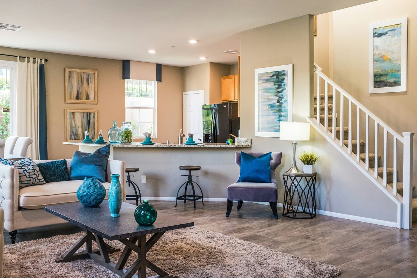 A made bed and a kitchen table in a settled home